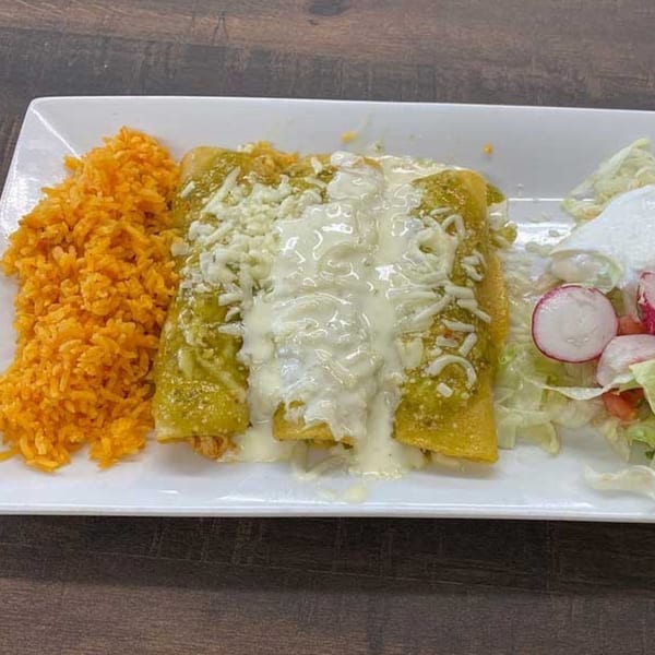 Three green enchiladas with white sauce and cheese, served with orange rice and a side salad.
