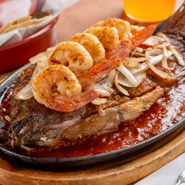 Whole fried fish topped with grilled shrimp and onions, served sizzling in red sauce.